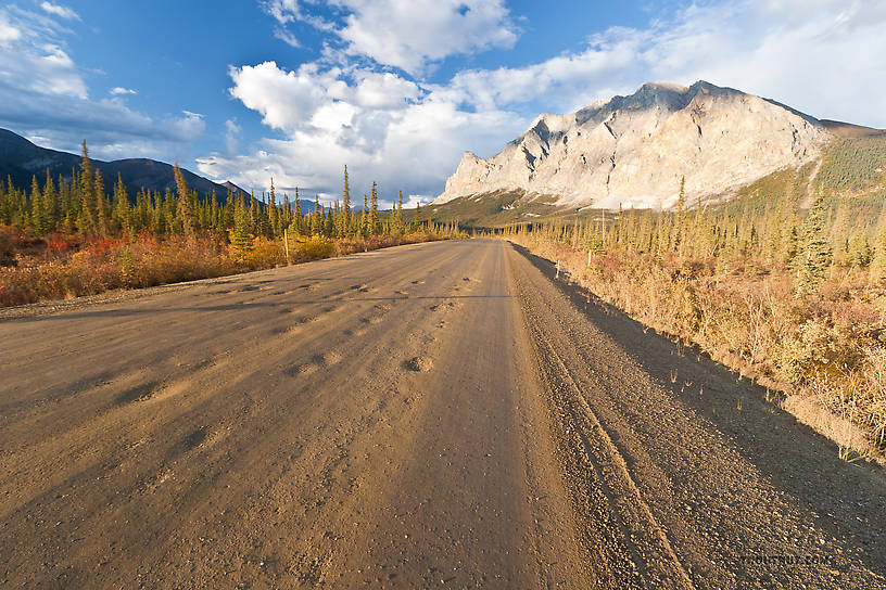 This is one of my favorite pictures -- I think it really captures the character of the place.  This is the view from the south of Sukakpak Mountain, a prominent landmark on the south side of the Brooks Range.  The Dalton Highway winds in an arc around Sukapak, providing very different views from different angles. From Dalton Highway in Alaska.