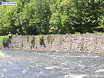 A beautiful deep current tongue runs along a manmade wall on a famous Catskill river. From the Beaverkill River in New York.