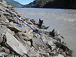 I spent twelve hours holding this net in the river, often in fast current.  The key is to hold it in an eddy, so it billows out upstream and can catch the salmon that are all swimming in that direction.  The eddies along the bank attract salmon because it's easier for them to run upstream with the current than against it.  The best eddies are the narrow ones where the rest of the river is flowing fast downstream most of the salmon hug the bank. From the Copper River in Alaska.