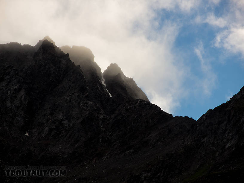 Clouds spilling over the mountaintops From Clearwater Mountains in Alaska.