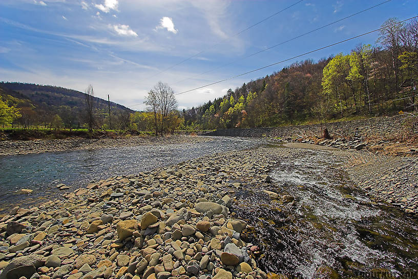 A swift tributary of a Catskill trout stream slides down its own high delta of boulders and cobble. From the Beaverkill River, Horton Bridge Pool in New York.