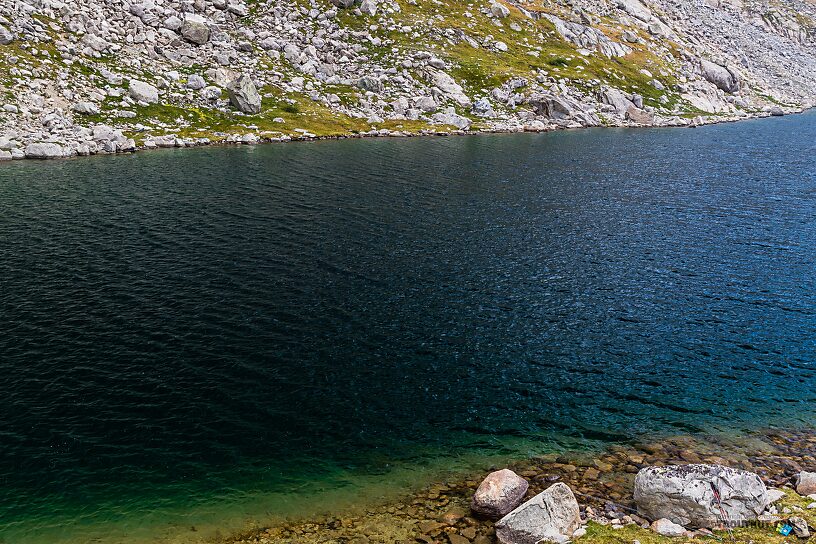 Deep dark waters of Mistake Lake From Titcomb Basin in Wyoming.