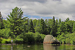 My dad works his way through the shallows of a smallmouth river.  The hole around the large boulder might shelter bass in normal water, but we floated this stretch during a prolonged drought and the fish had left the shallows. From the West Fork of the Chippewa River in Wisconsin.