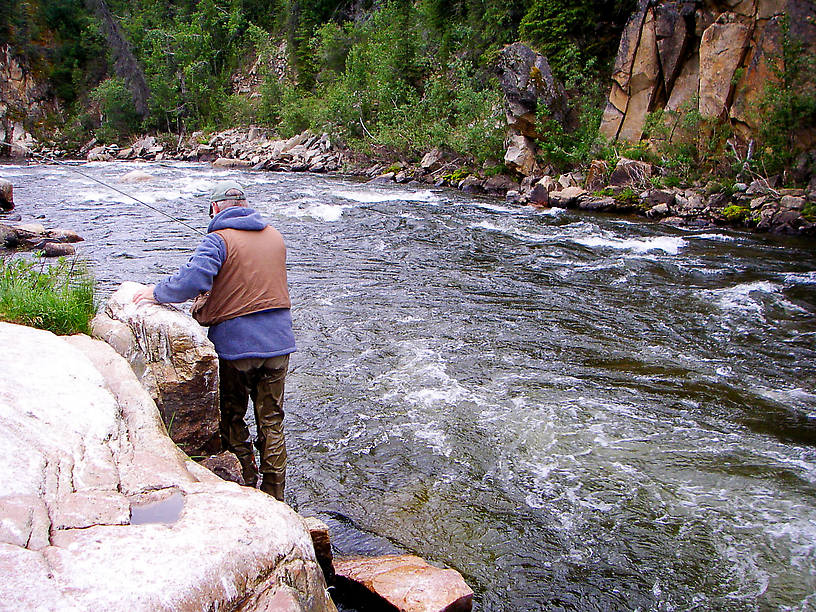 My dad scrambles along the rocks at the base of this canyon as an 18-inch, wild Alaskan rainbow gives him the best fight he's ever had from a fish. From the Gulkana River in Alaska.