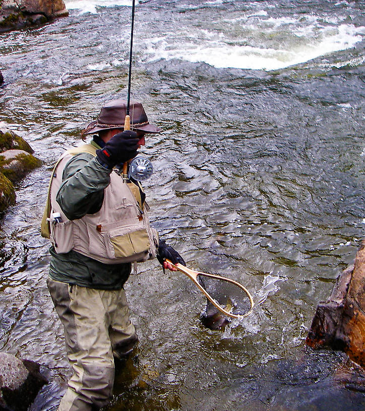 Here I'm netting a nice rainbow in the rapids. From the Gulkana River in Alaska.