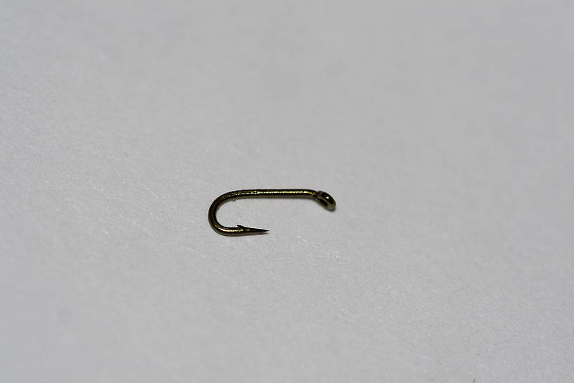 Here it is, next to a size-26 hook for comparison.