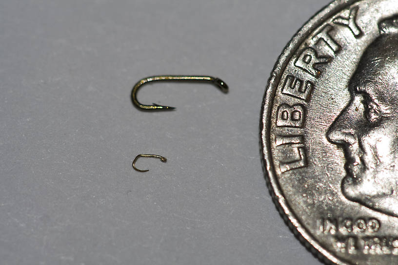 Here is the hook again, with a dime to give perspective.  I had another shot with a ruler, but it got inadvertently deleted.  It is 2.0 mm long, compared with the 6-mm long size-26.