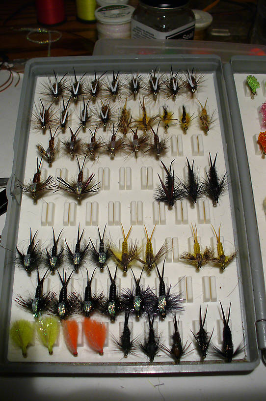 From the top down; five flies in row #3 have loop spun thoraxes, the two flies on the left in row #4, the first five flies on the left of row #6, and the first three black stones ion the left in row #7. The other three have black Estaz thoraxes.  The legs of the first three of row #7 are black Krystal Flash.